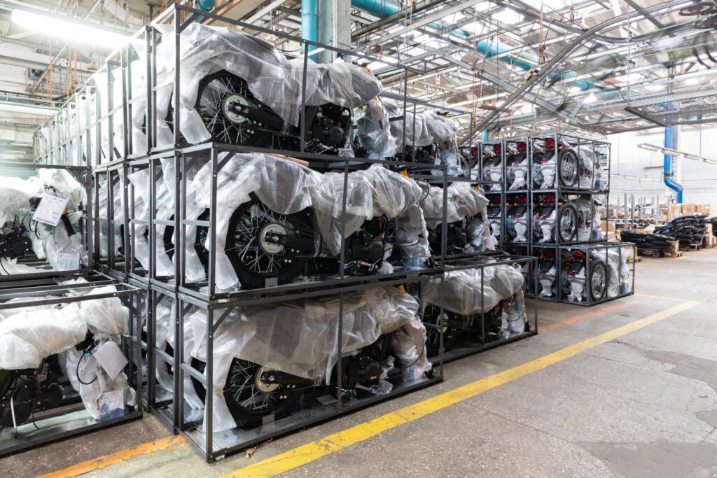 many new motorcycles in packages at the motorcycle and moped assembly plant