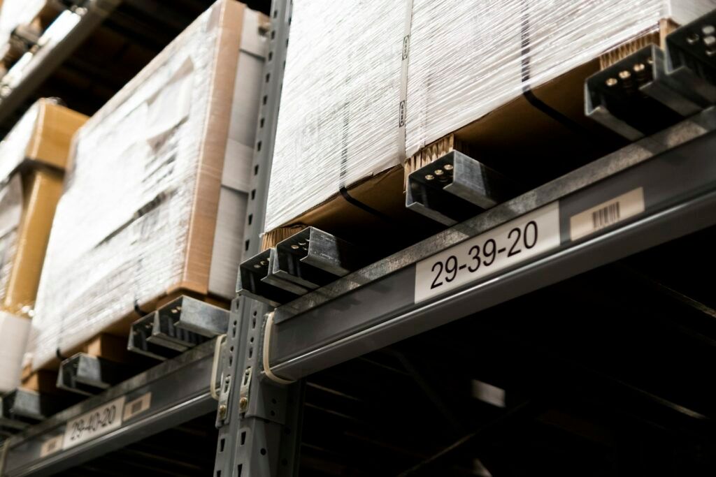 Cartons on warehouse racking with a printed location label