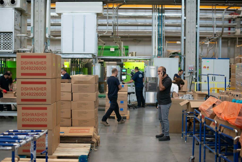 Warehouse team working among stacked cartons in a fulfilment centre
