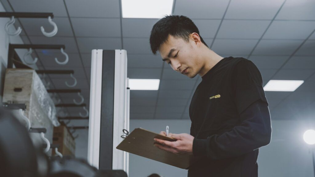 Warehouse worker checking stock quantities on a clipboard