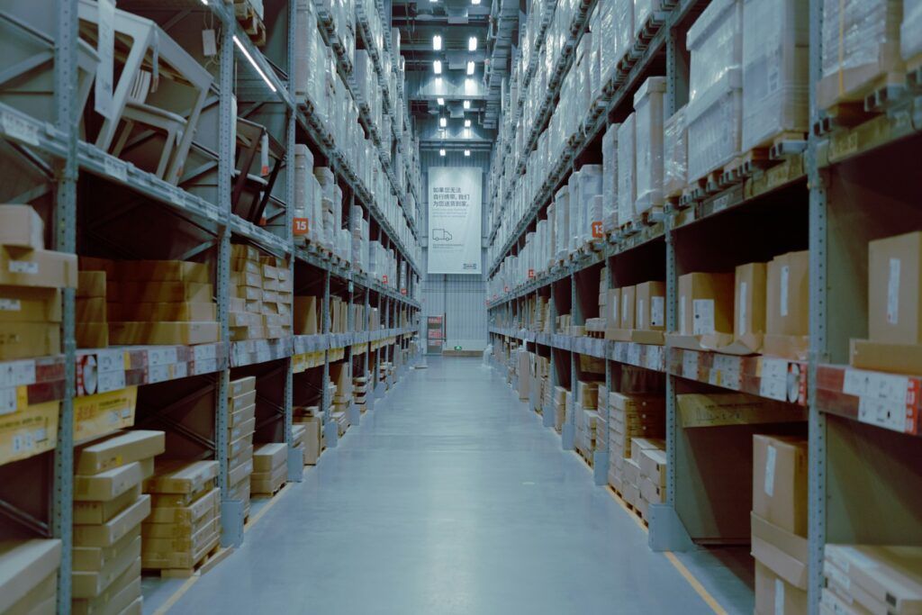 Long warehouse aisle with labelled boxes on tall shelves